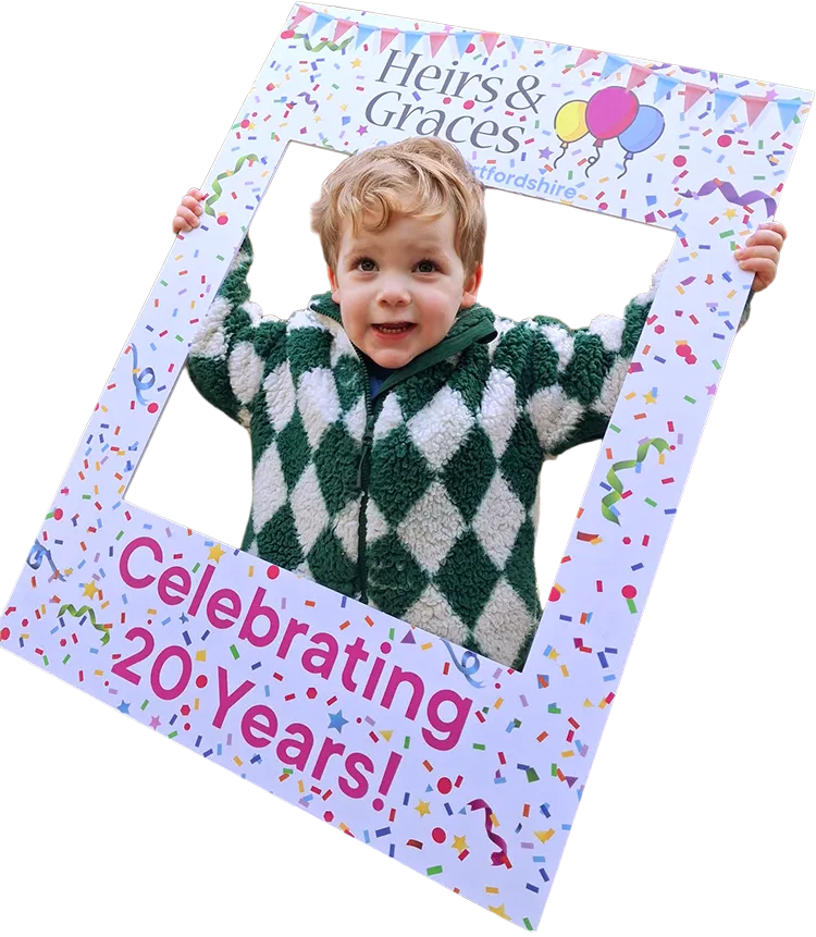 Child holding Heirs & Graces Hertfordshire celebrating 20 years frame in Tring